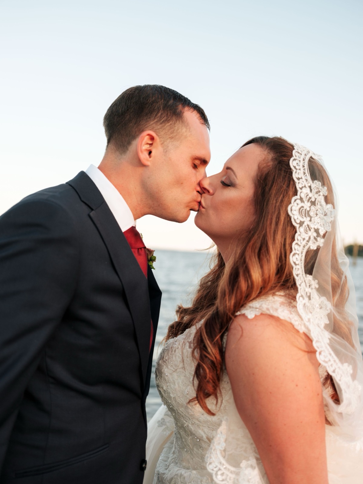 Emily and Adam walking together across the lawn at Copper on the Neuse