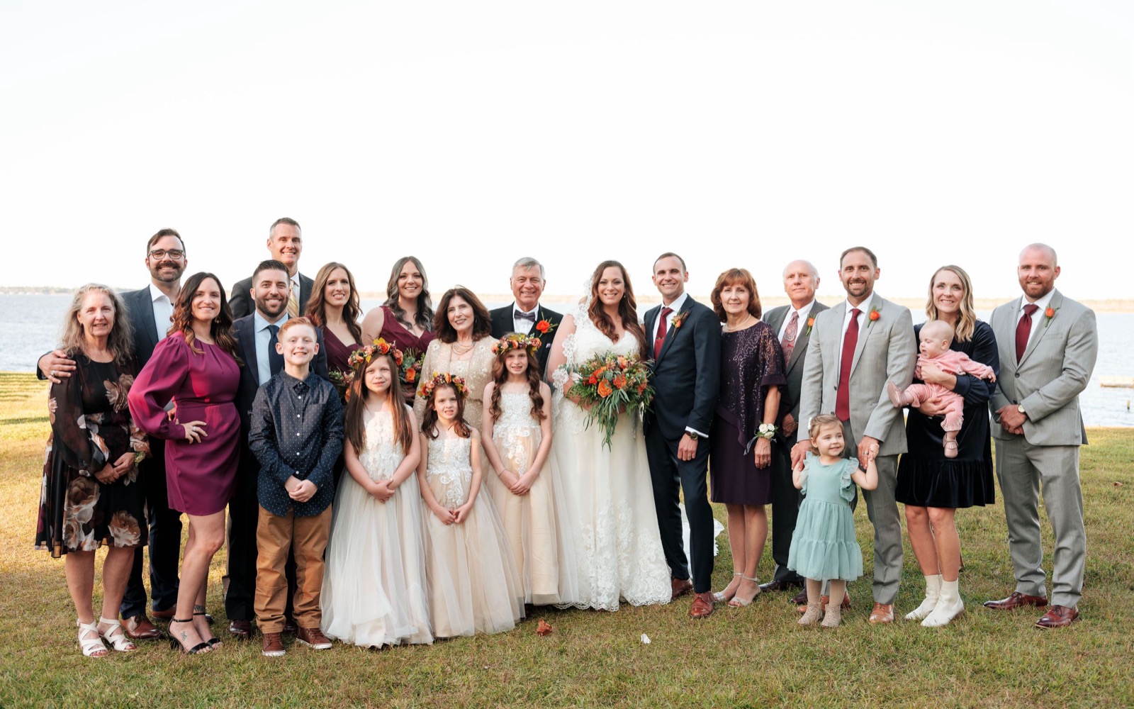 Emily and Adam with their wedding party beside the water in New Bern