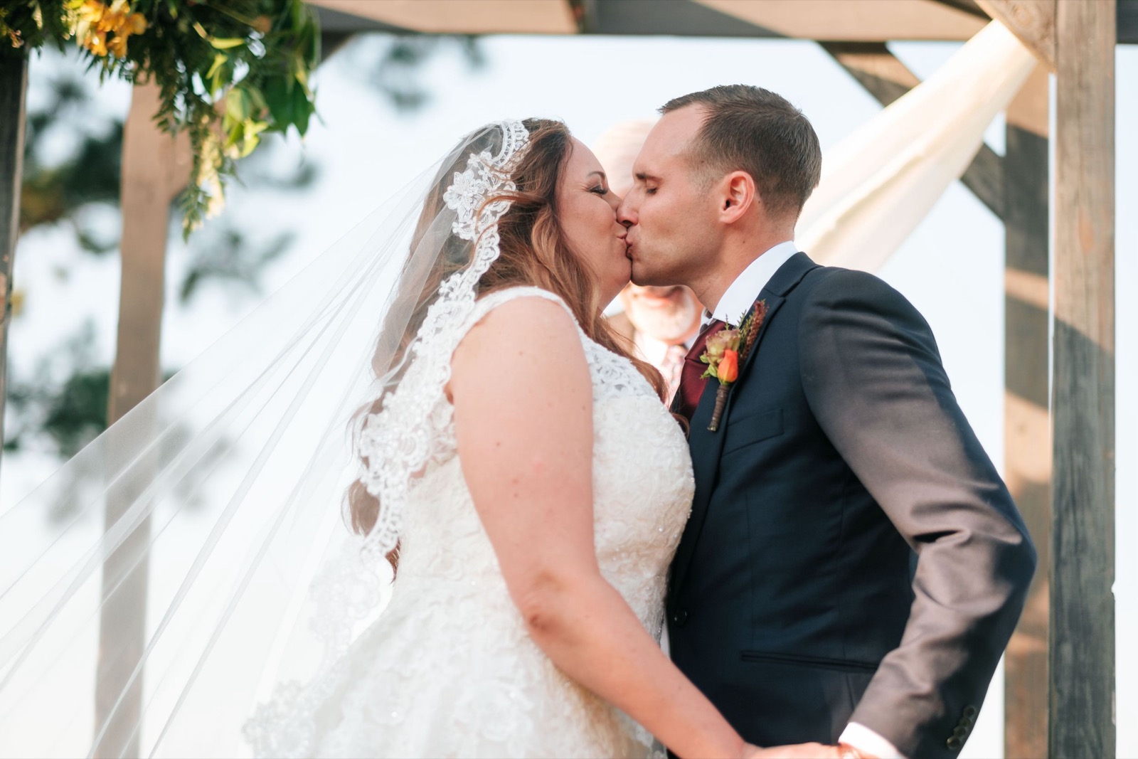 Emily and Adam together beneath the wedding veil