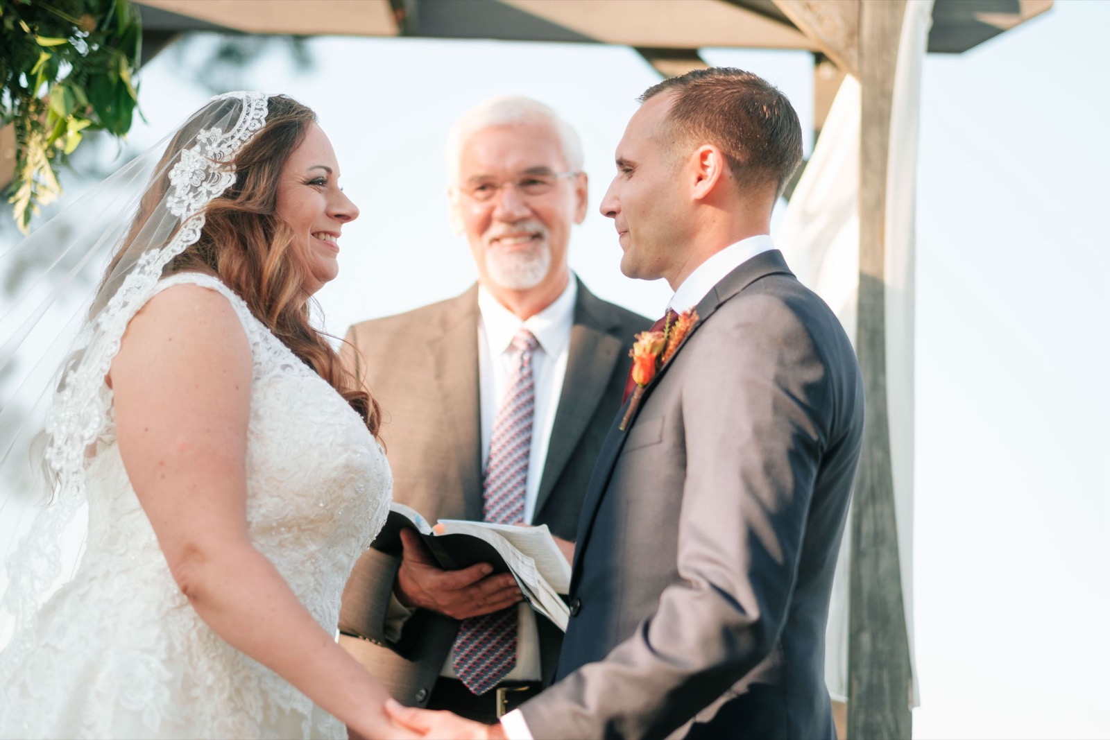 The couple facing each other during their wedding ceremony