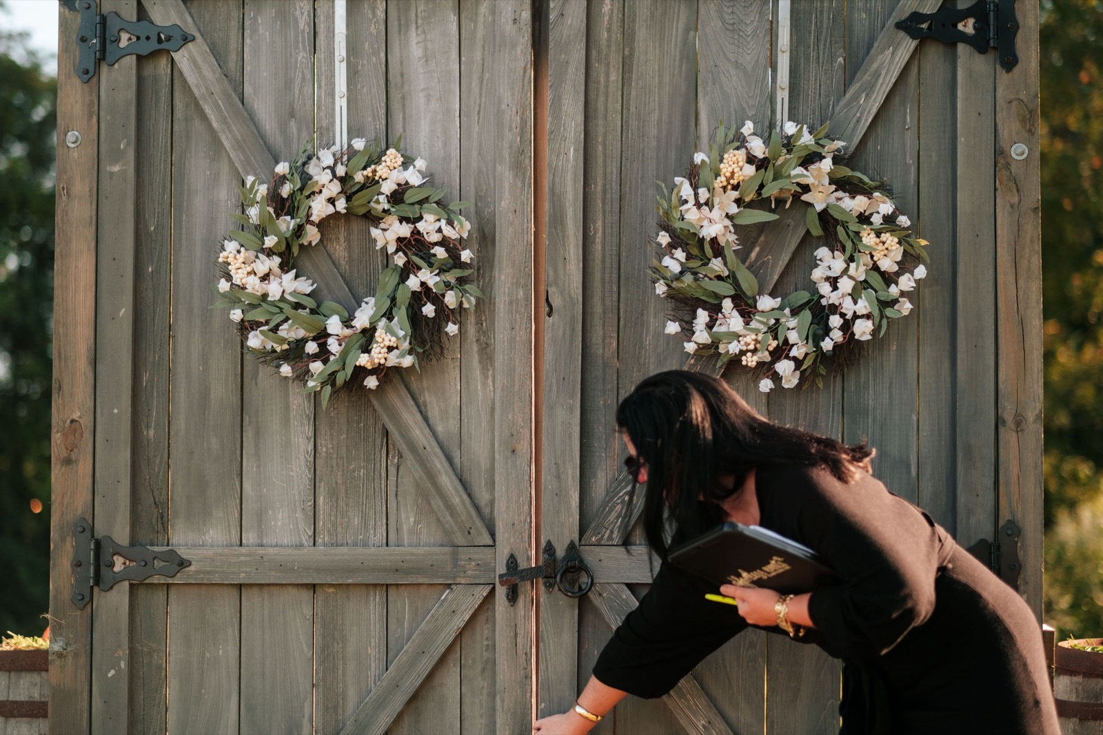 A hand kiss at the wooden doors of Copper on the Neuse